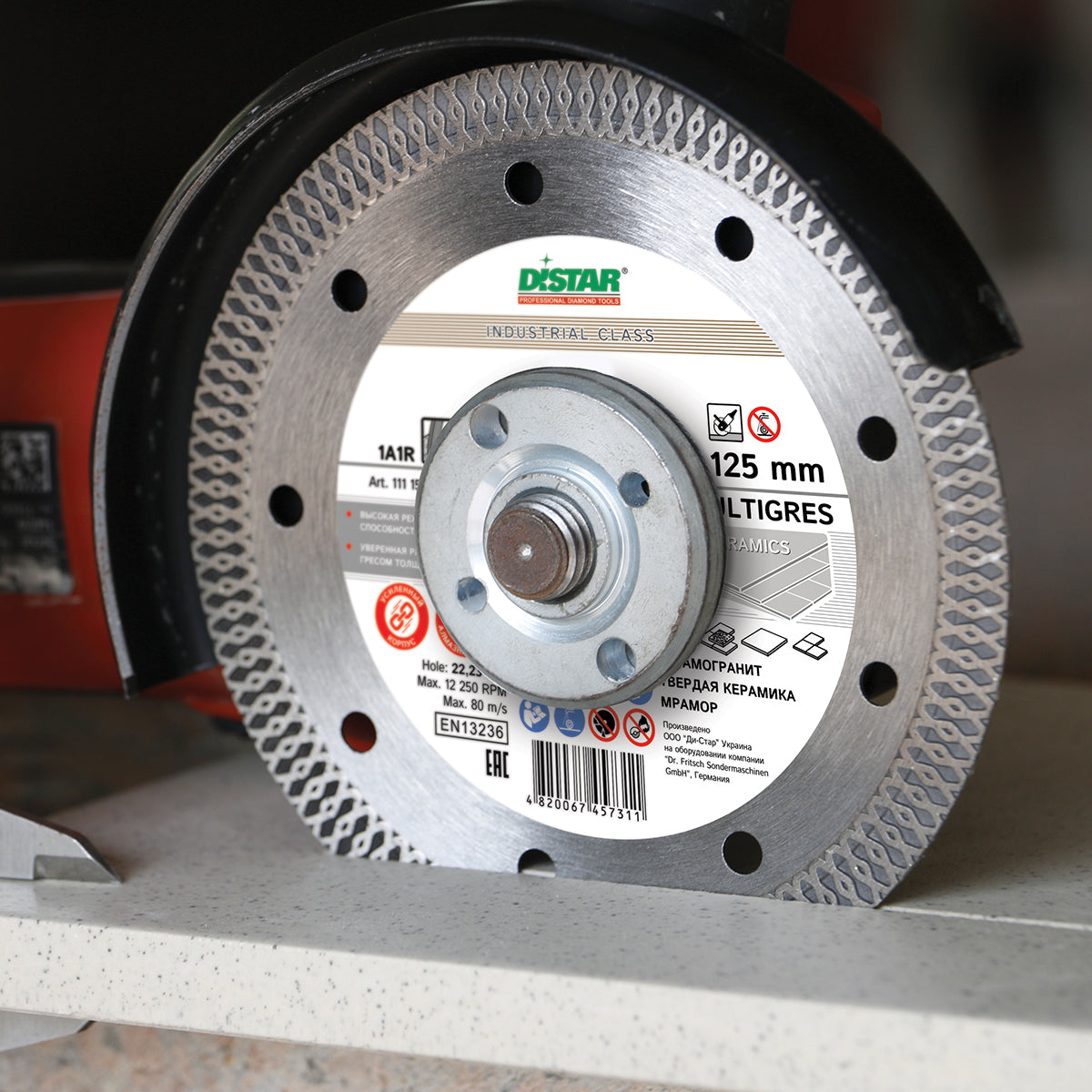 Distar MULTIGRES 125 mm diamond disc mounted on angle grinder for tile cutting